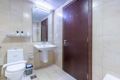 a bathroom with a toilet and a sink at RH- Bright 1BR in JVC, near Circle mall in Dubai
