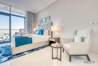 a bedroom with a bed and a chair at Peaceful Studio at Celestia A Dubai South by Deluxe Holiday Homes in Dubai
