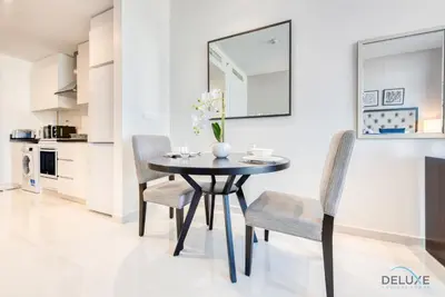 a dining room with a black table and chairs at Peaceful Studio at Celestia A Dubai South by Deluxe Holiday Homes in Dubai