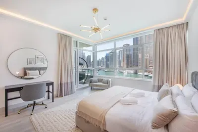 a bedroom with a large bed and a large window at Astonishing 3BDR in the heart of Dubai Marina in Dubai