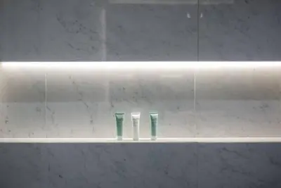 two toothbrushes sitting on a shelf in a bathroom at Astonishing 3BDR in the heart of Dubai Marina in Dubai