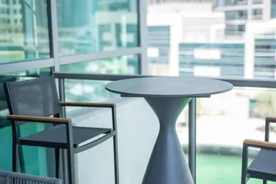 a table and chairs in front of a window at Astonishing 3BDR in the heart of Dubai Marina in Dubai