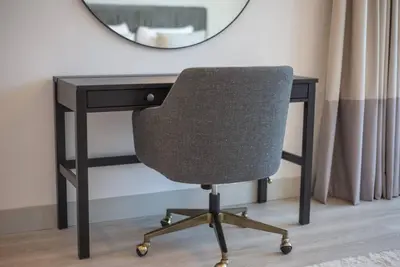 a desk with a chair in front of a mirror at Astonishing 3BDR in the heart of Dubai Marina in Dubai