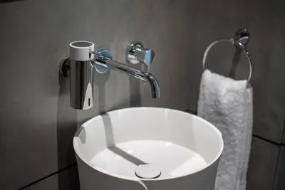 a white sink in a bathroom with a faucet at Fantastic Studio resort style facilities - OFFER in Dubai