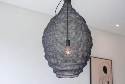 a pendant light hanging from a ceiling at Fantastic Studio resort style facilities - OFFER in Dubai