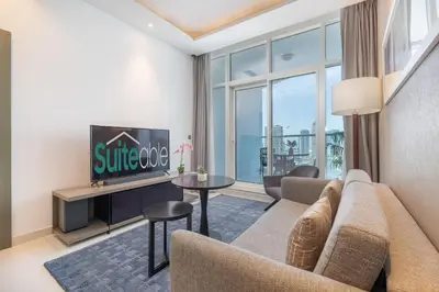 a living room with a couch and a tv at Spectacular Burj Khalifa view service apartment in Dubai