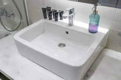 a bathroom sink with a soap bottle on it at Spectacular Burj Khalifa view service apartment in Dubai