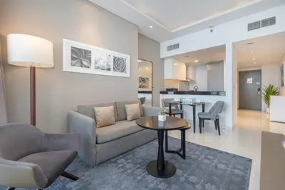 a living room with a couch and a table at Spectacular Burj Khalifa view service apartment in Dubai