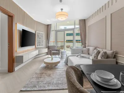 a living room with a couch and a tv at Cozy Retreat 1Bedroom on the Business Bay Canal by Suiteable Interiors in Dubai