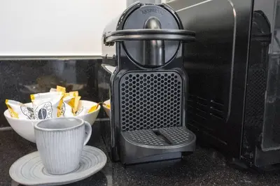a coffee maker sitting on a counter next to a microwave at At The Top Burj View STUDIO - Special offer in Dubai