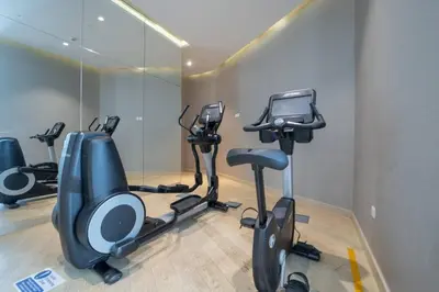 a gym with several exercise bikes in a room at At The Top Burj View STUDIO - Special offer in Dubai