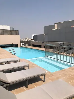 a swimming pool on the roof of a building at Azur Regency Hotel Apartments in Dubai