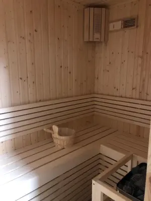 a sauna with a basket on the inside of it at Azur Regency Hotel Apartments in Dubai