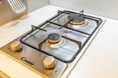 a stove top with two burners on top of it at Unique loft with smart working station in Dubai