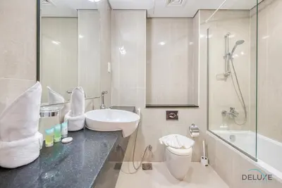 a bathroom with a sink and a toilet and a shower at Cozy Studio at The Matrix Sports City by Deluxe Holiday Homes in Dubai
