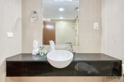 a bathroom with a sink and a mirror at Cozy Studio at The Matrix Sports City by Deluxe Holiday Homes in Dubai