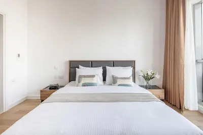 a bedroom with a large white bed with pillows at Frank Porter - Bay Central Tower 1 in Dubai