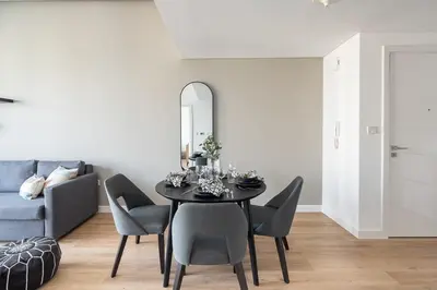 a dining room with a black table and chairs at Frank Porter - Bay Central Tower 1 in Dubai