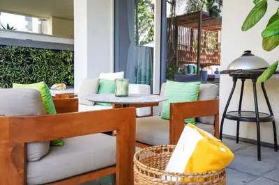 a patio with chairs and a table and a table at Private Pool Apt. Five Palm Jumeirah up to 6guest in Dubai