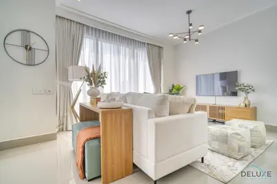 a living room with a white couch and a table at Extravagant 1BR at Opera Grand Downtown Dubai by Deluxe Holiday Homes in Dubai