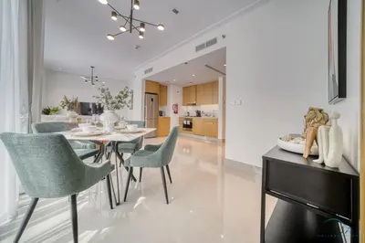 a dining room and kitchen with a table and chairs at Extravagant 1BR at Opera Grand Downtown Dubai by Deluxe Holiday Homes in Dubai