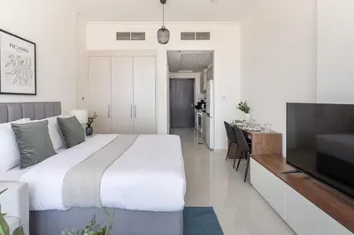 a bedroom with a large bed and a flat screen tv at Frank Porter - Carson Tower C in Dubai