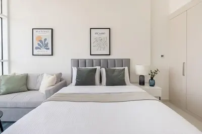 a bedroom with a large bed and a couch at Frank Porter - Carson Tower C in Dubai