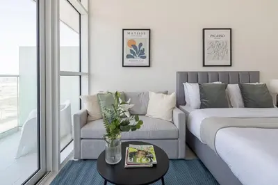 a living room with a couch and a table at Frank Porter - Carson Tower C in Dubai