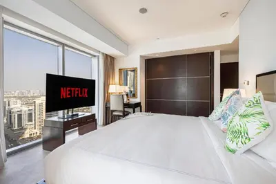 a bedroom with a large white bed with a sign on it at Daniels 1BR at JW Marriott with Dubai Marina View in Dubai
