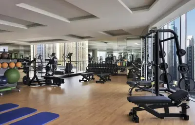 a gym with lots of treadmills and machines at Daniels 1BR at JW Marriott with Dubai Marina View in Dubai