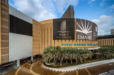 a building with a sign for the durant parking hall at Daniels 1BR at JW Marriott with Dubai Marina View in Dubai