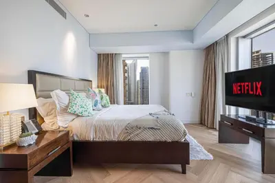a bedroom with a bed with a television in it at Daniels 1BR at JW Marriott with Dubai Marina View in Dubai
