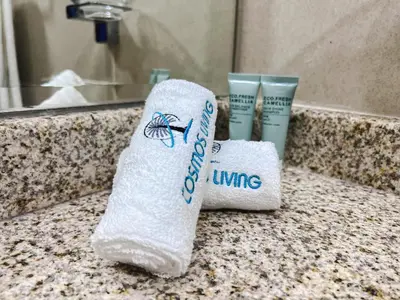 a roll of towels sitting on a bathroom counter at Cosmos Living Modern Studio Near Dubai Marina in Dubai