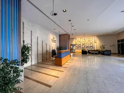 a lobby of a building with a couch and chairs at Cosmos Living Modern Studio Near Dubai Marina in Dubai
