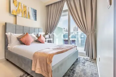 a bedroom with a bed and a large window at Staycae Holiday Homes - Reva in Dubai