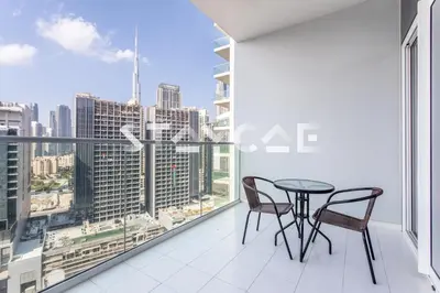a table and chairs on a balcony with a view of the city at Staycae Holiday Homes - Reva in Dubai