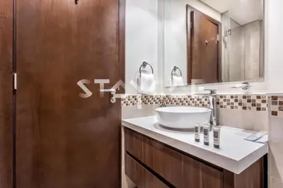 a bathroom with a sink and a mirror at Staycae Holiday Homes - Reva in Dubai