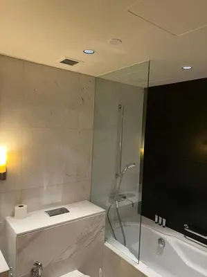 a bathroom with a shower and a sink and a tub at Address Dubai Mall Fashion Avenue Full Burj Khalifa views Studio in Dubai