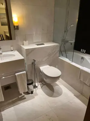 a bathroom with a toilet and a sink and a tub at Address Dubai Mall Fashion Avenue Full Burj Khalifa views Studio in Dubai