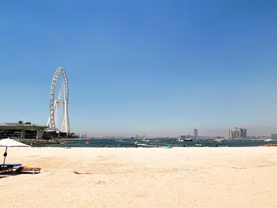 a beach with a ferris wheel in the background at Address JBR Sea Views, Jumeirah Beach Residence, Dubai Marina - Mint Stay in Dubai