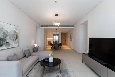 a living room with a couch and a television at Address JBR Sea Views, Jumeirah Beach Residence, Dubai Marina - Mint Stay in Dubai