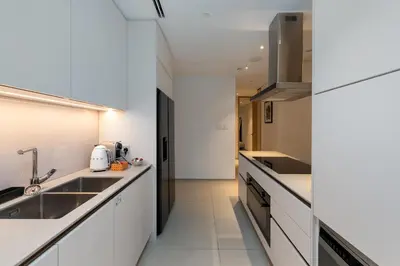 a kitchen with white counters and a sink at Address JBR Sea Views, Jumeirah Beach Residence, Dubai Marina - Mint Stay in Dubai