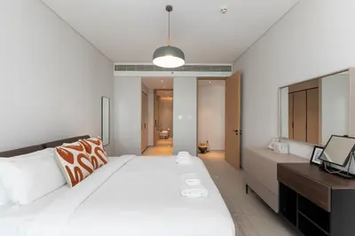 a bedroom with a large white bed and a television at Address JBR Sea Views, Jumeirah Beach Residence, Dubai Marina - Mint Stay in Dubai