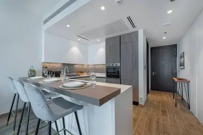 a kitchen with a island with chairs and a counter top at Luxury apartment 38th floor Dubai MarinaEXPO OFFER in Dubai