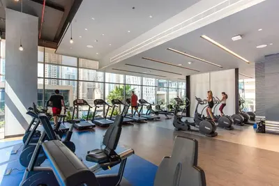 a gym with a bunch of treadmills and people in it at Luxury apartment 38th floor Dubai MarinaEXPO OFFER in Dubai