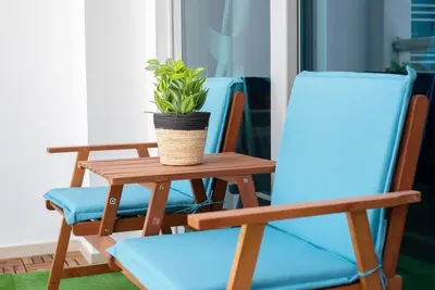 a table with two chairs and a potted plant on it at Classic Studio With Dubai Marina View in Dubai