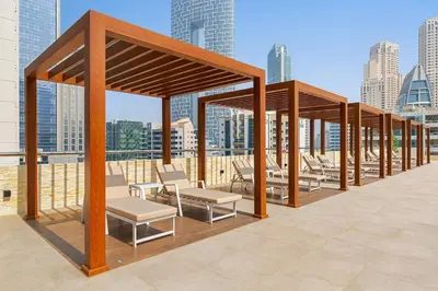 a row of chairs and tables on the roof of a building at Classic Studio With Dubai Marina View in Dubai