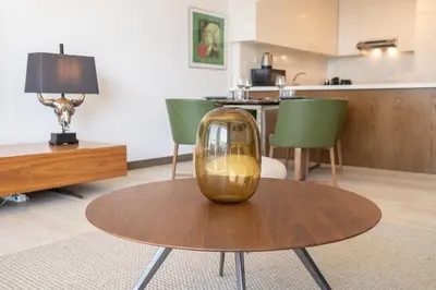 a table with a vase sitting on top of it at Elegant 1br in Zaya Hameni in Dubai