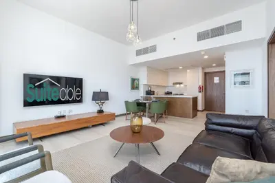 a living room with a couch and a table at Elegant 1br in Zaya Hameni in Dubai
