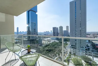 a balcony with chairs and a view of the city at Elegant 1br in Zaya Hameni in Dubai